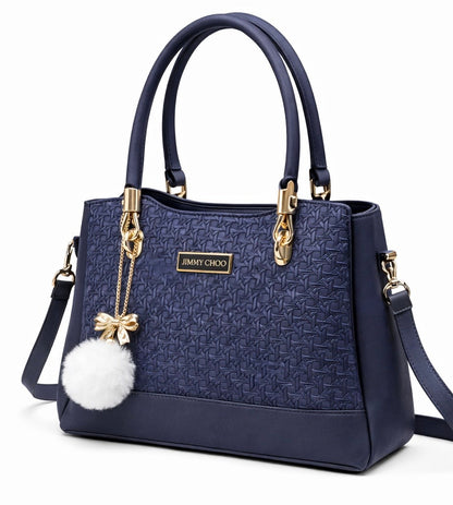 Elegant Designer Handbag with Gold Hardware & Pom-Pom Charm