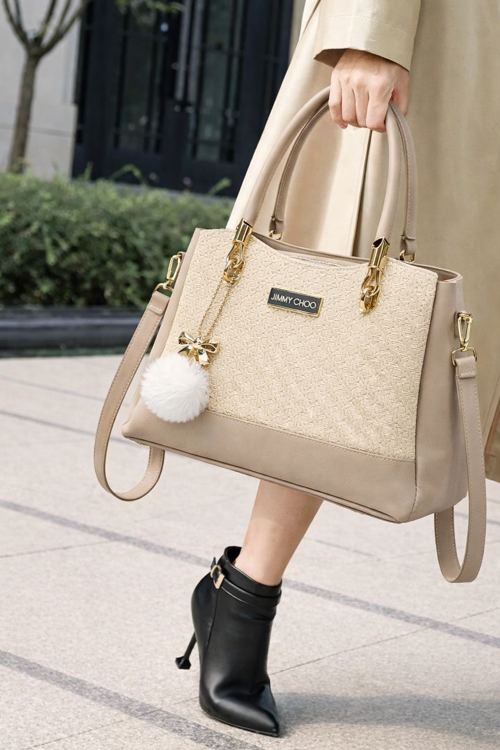 Elegant Beige Designer Handbag with Gold Hardware & Pom-Pom Charm