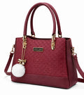 Elegant Mahroon Designer Handbag with Gold Hardware & Pom-Pom Charm