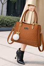 Elegant Camel Brown Designer Handbag with Gold Hardware & Pom-Pom Charm